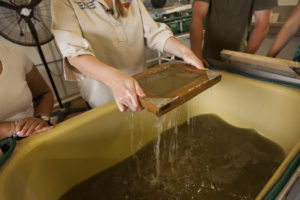 Once the pulp is beaten, we drain the water out to make sheets of paper