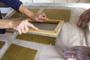 We turn the wet sheets of Curtin Springs Paper onto the 'post' ready to go into the press